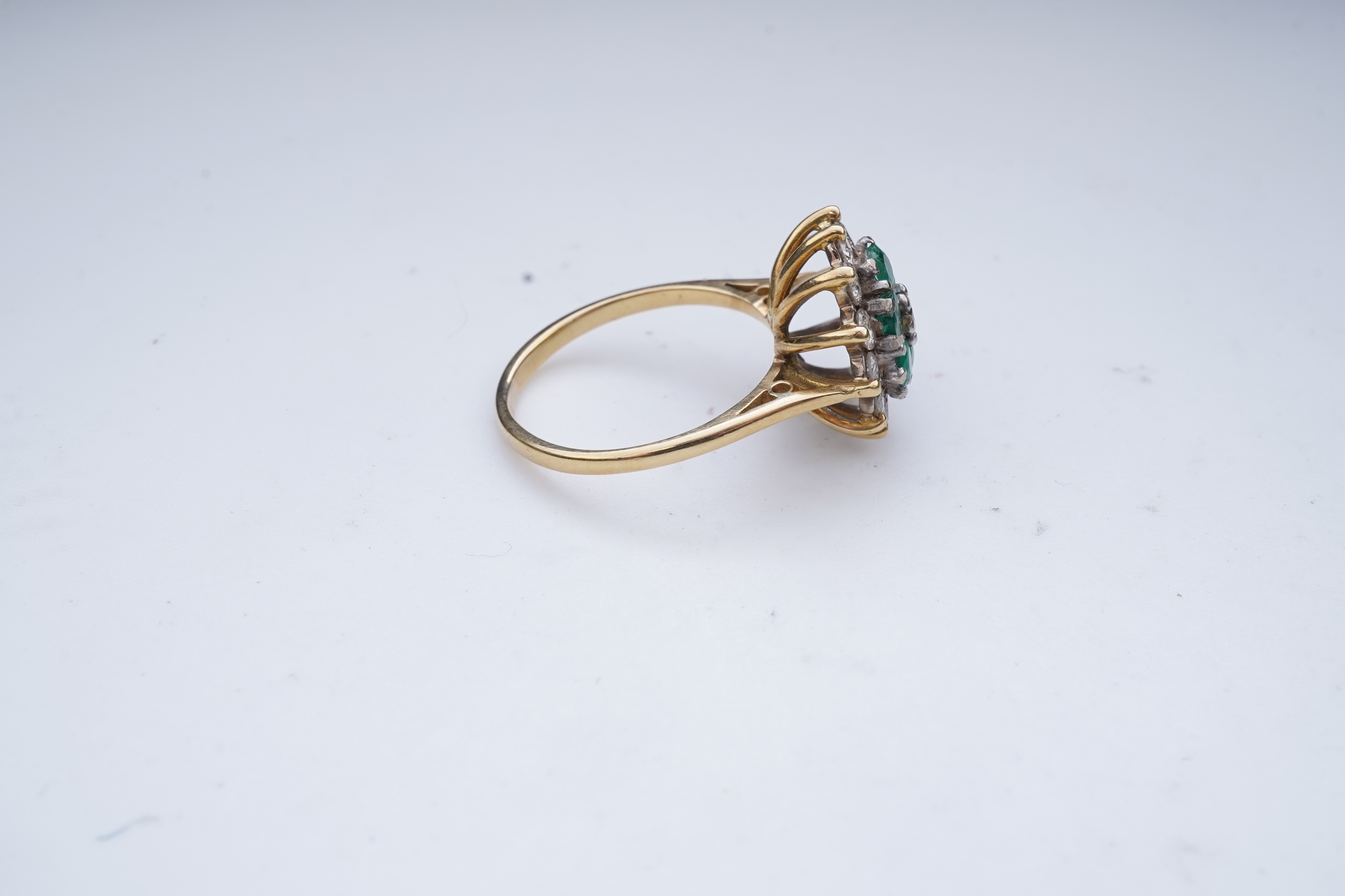 An emerald and diamond ring